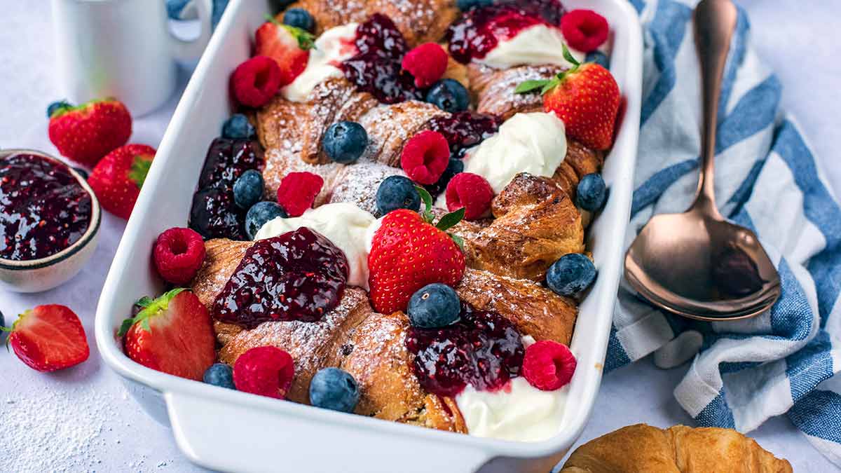 Baked croissants topped with yogurt, jam, blueberries, strawberries and raspberries.