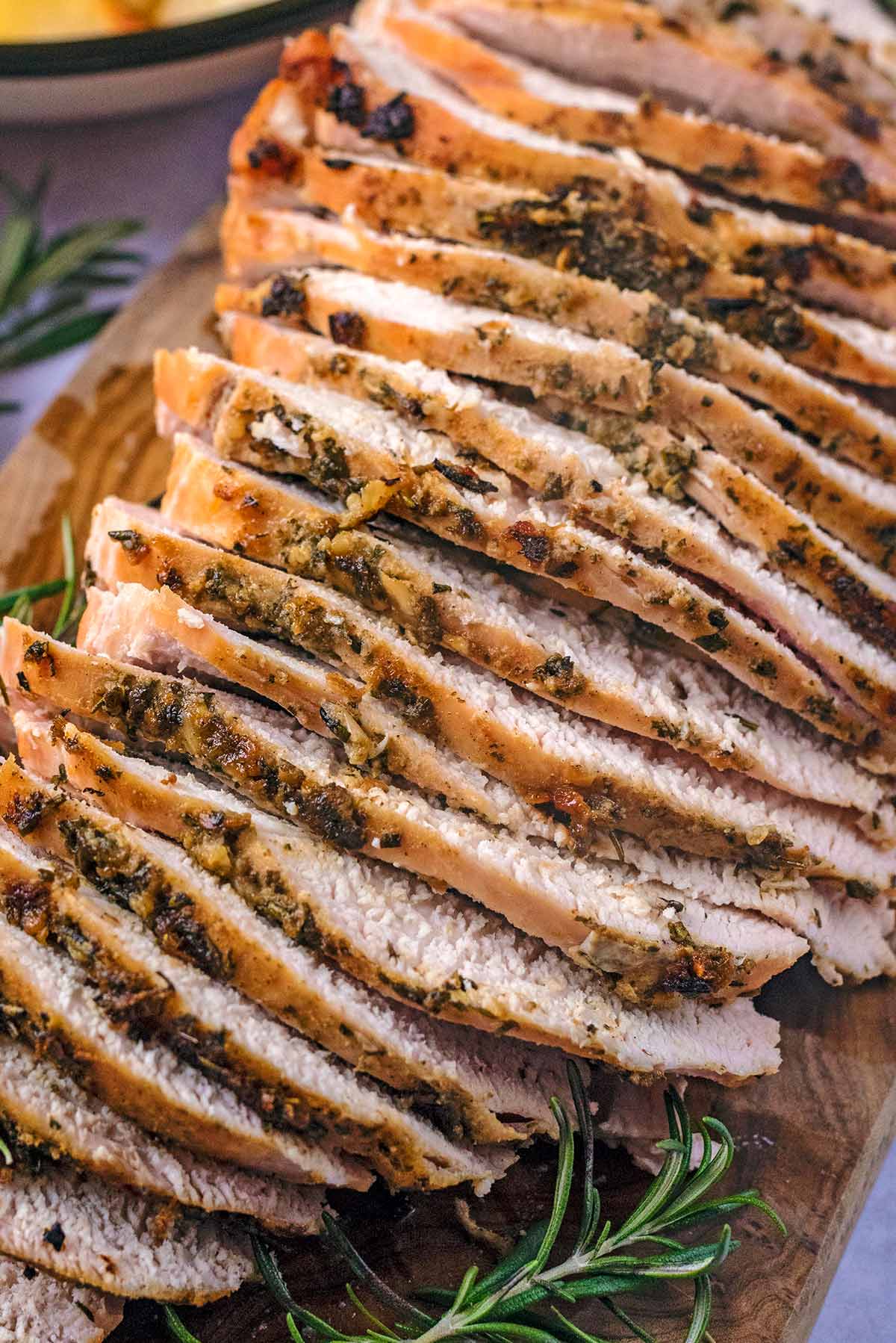 Sliced turkey breast with a herb edge.