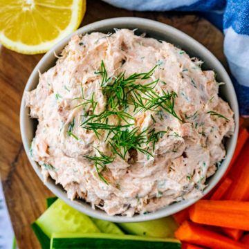Salmon pate in a bowl topped with fresh dill.
