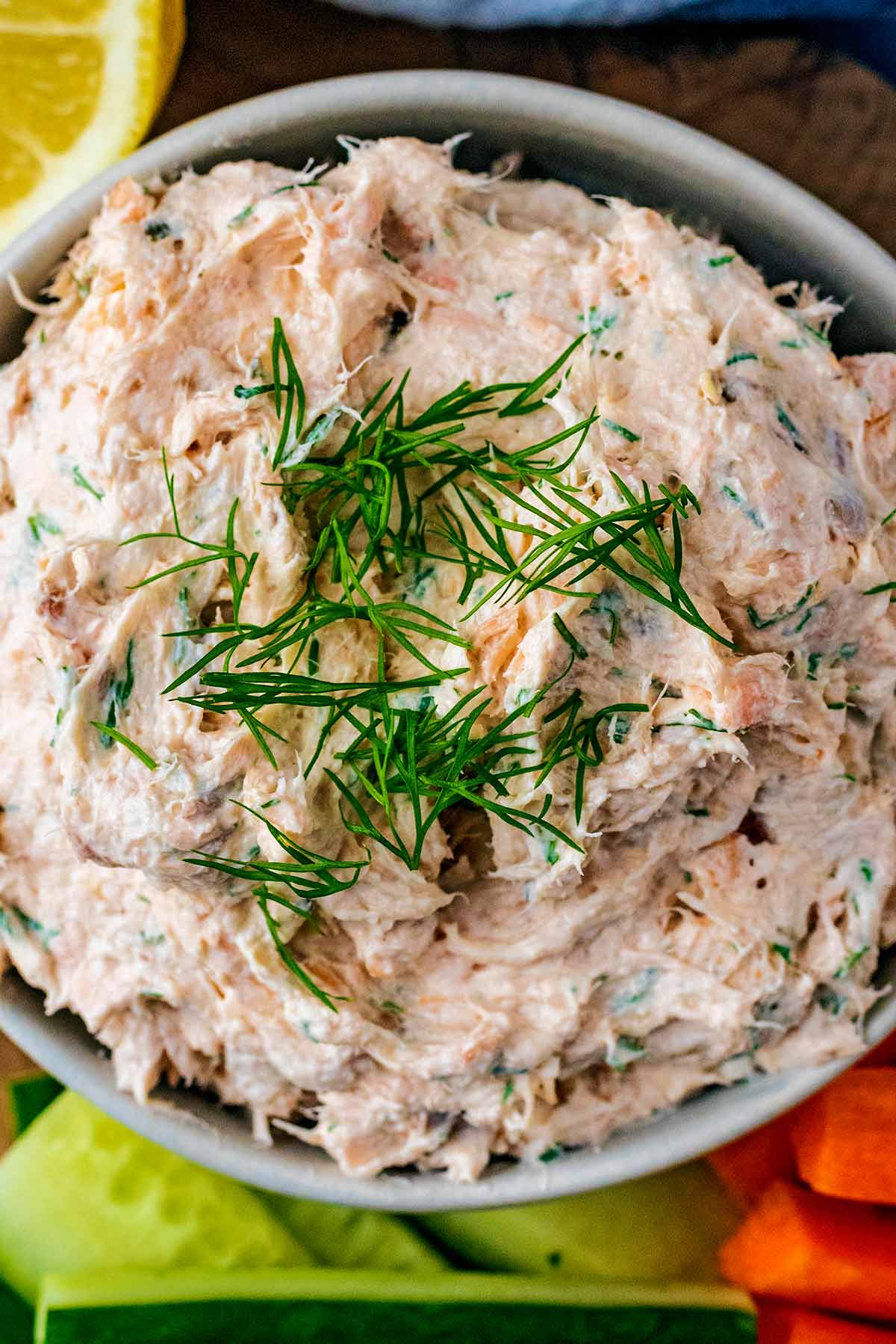 A bowl of pate with chopped dill on top.