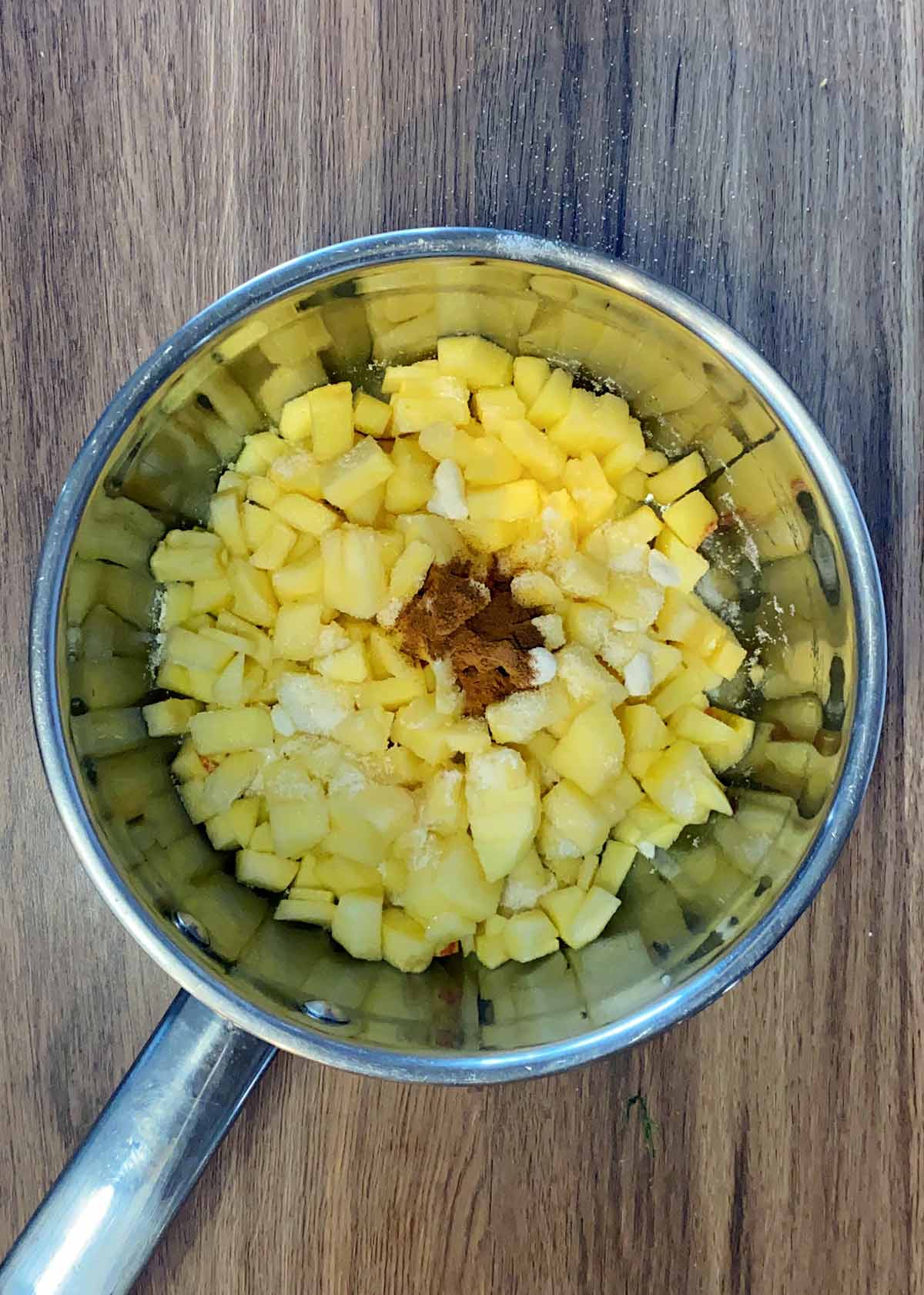 Chopped apples, sugar and cinnamon in a saucepan.