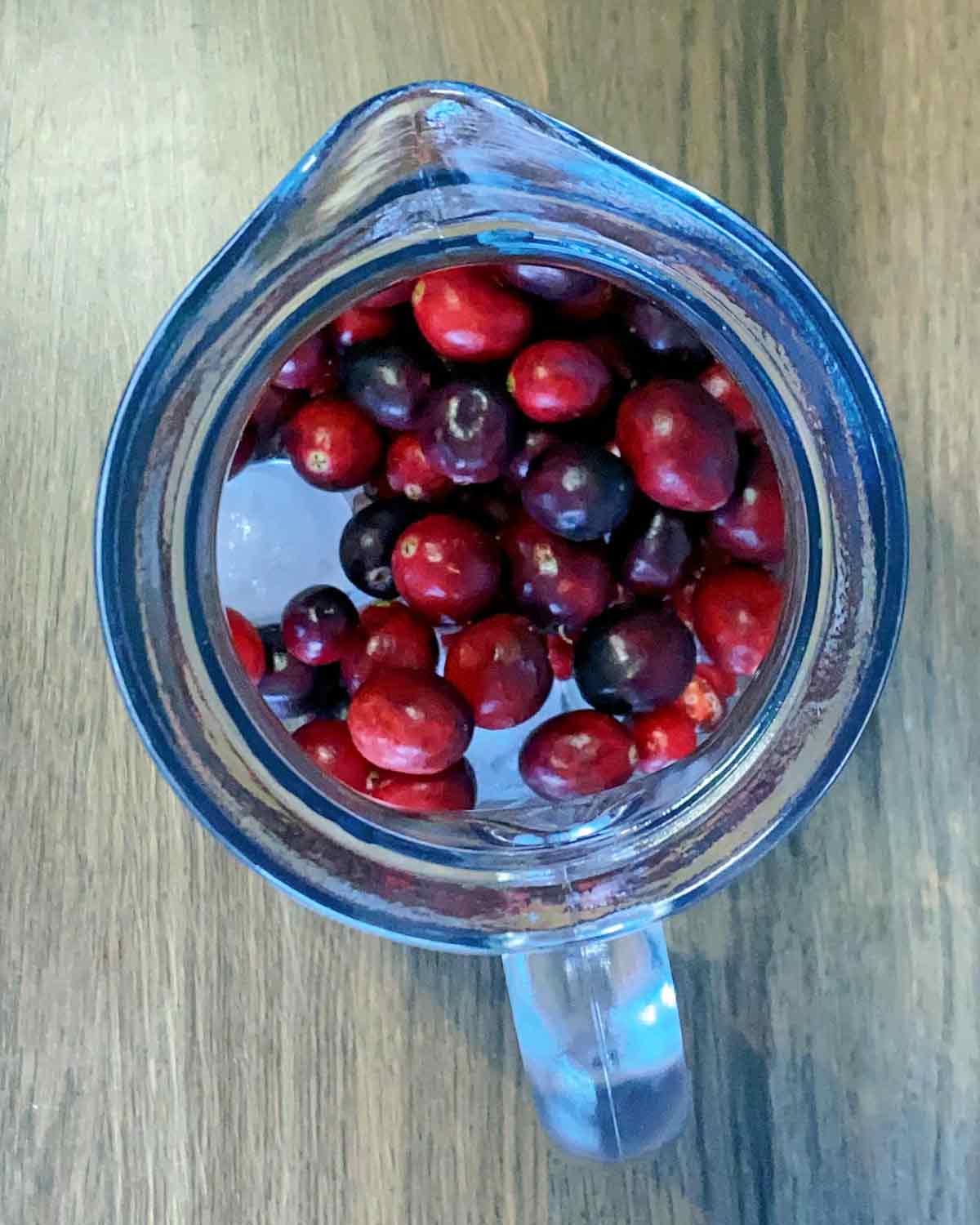 Fresh cranberries added to the jug.