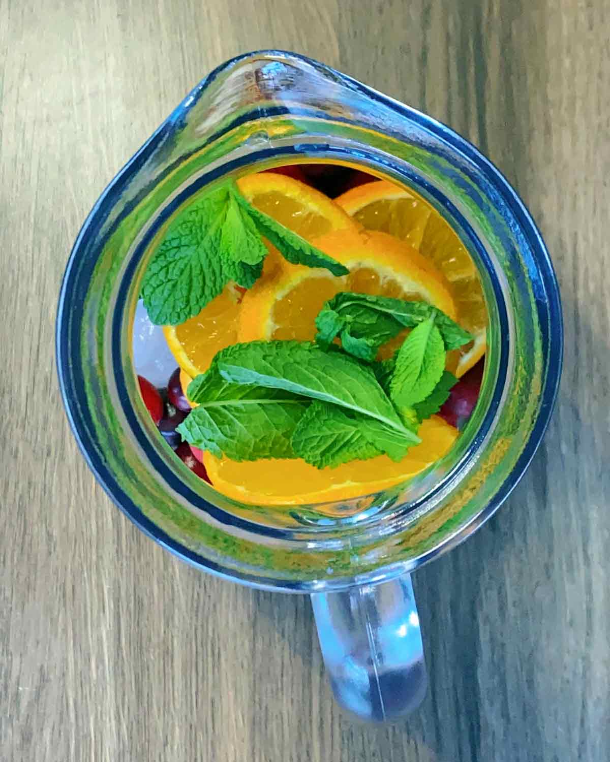 Clementine slices and mint leaves added to the jug.
