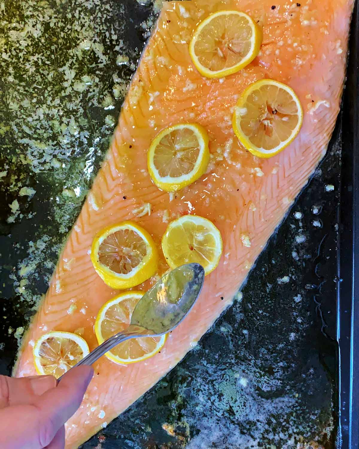 A side of salmon being basted.