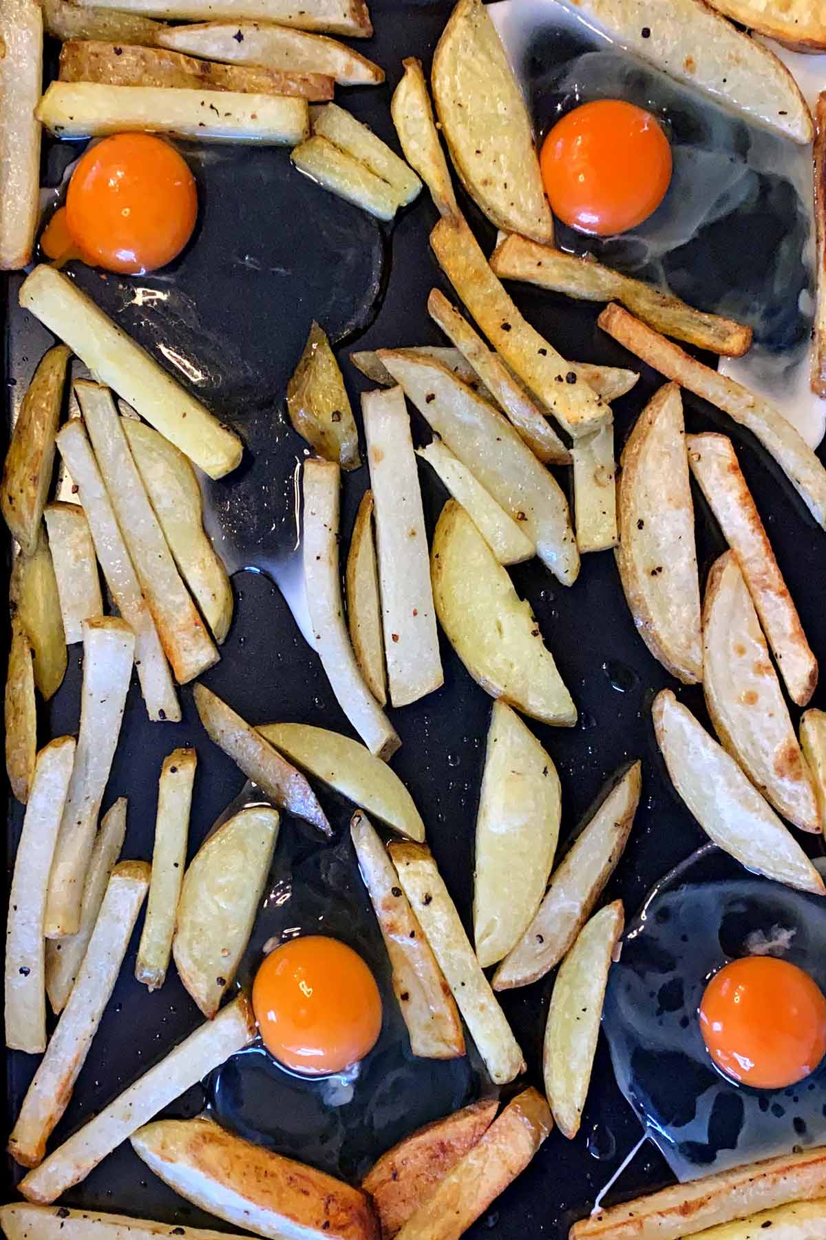 Four eggs cracked onto the baking tray.