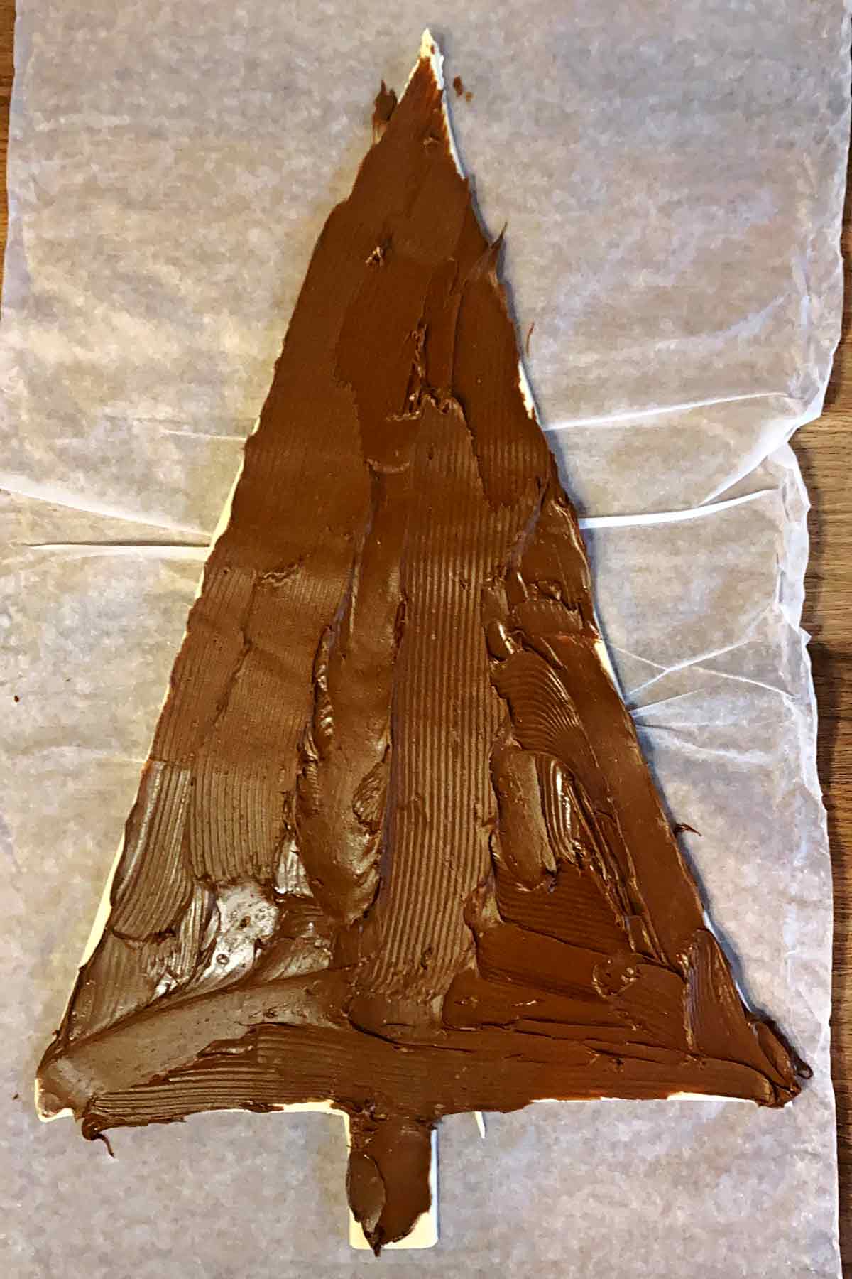A tree shape cut from pastry covered in chocolate spread.