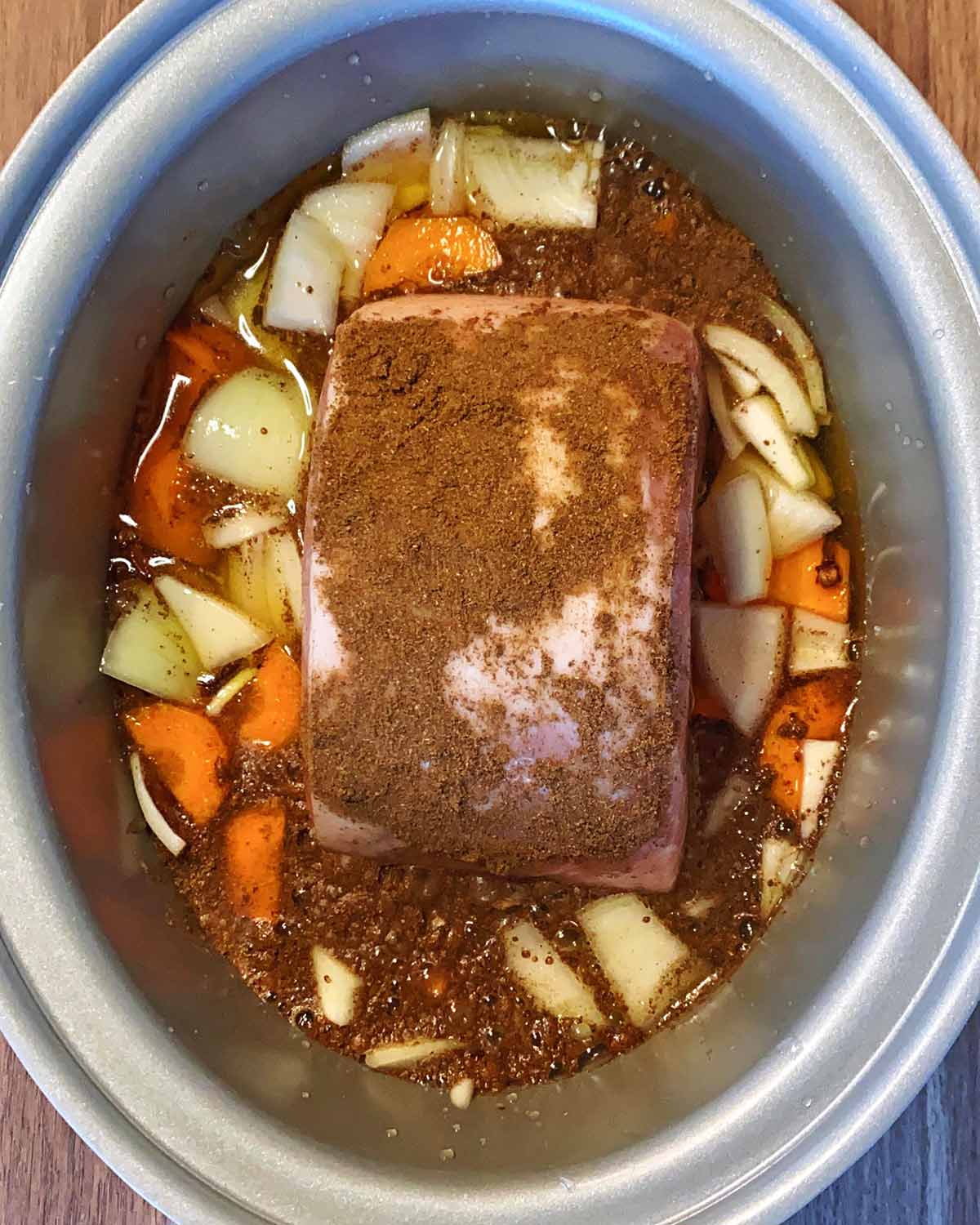 Spices rubbed over the gammon and liquid added to the slow cooker.