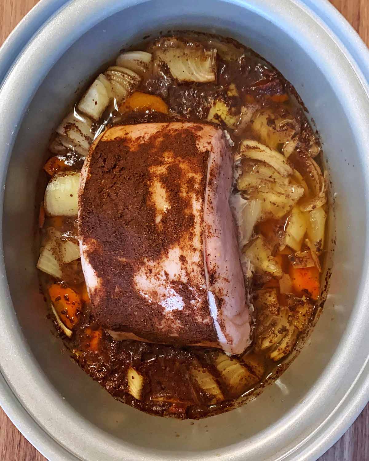 Cooked gammon and vegetables in the slow cooker.