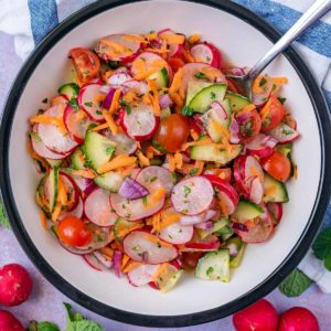 Cucumber and Radish Salad in a round serving bowl.