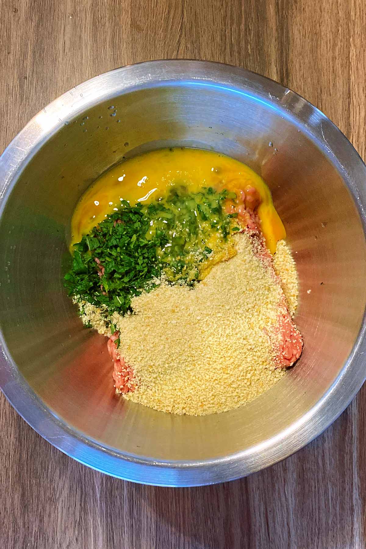 Breadcrumbs and egg added to the bowl.