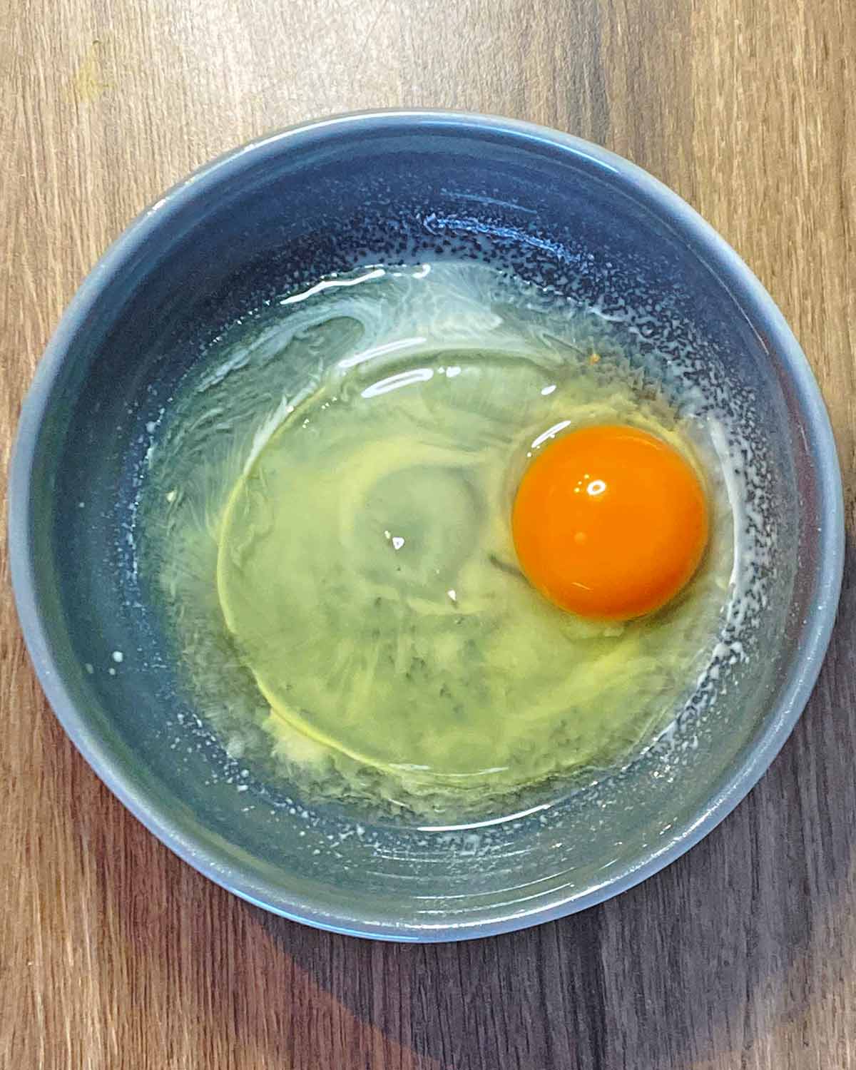 An egg cracked into the bowl.