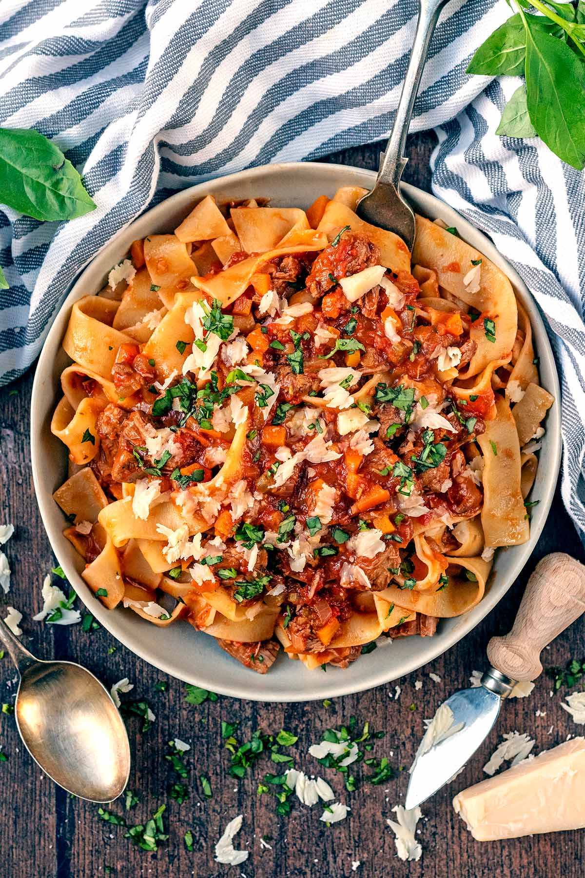 A bowl of pappardelle pasta mixed into a meat ragu.