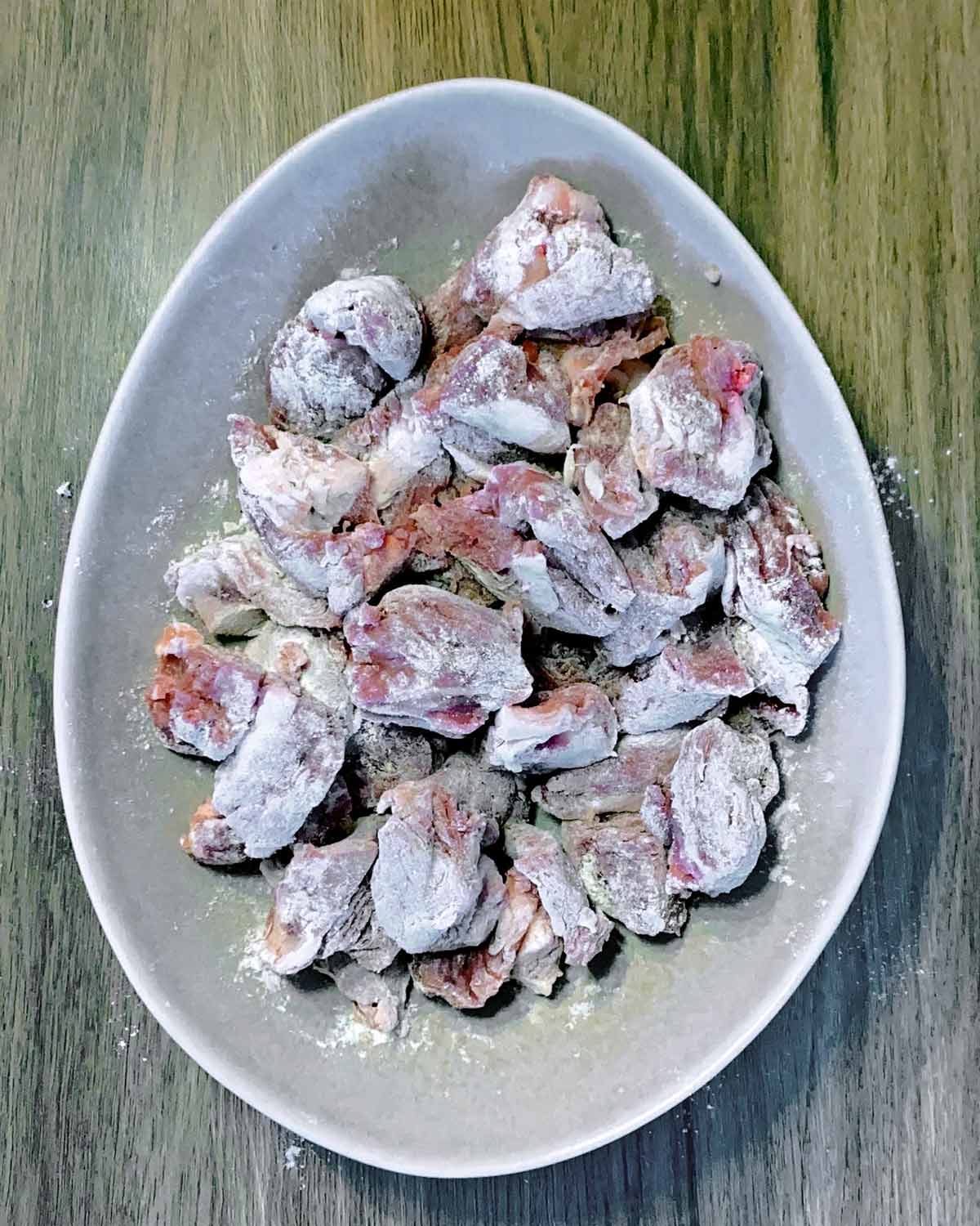 Chunks of lamb coated in seasoned flour.