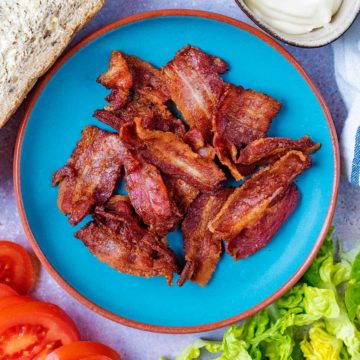 Air Fryer bacon on a blue plate.