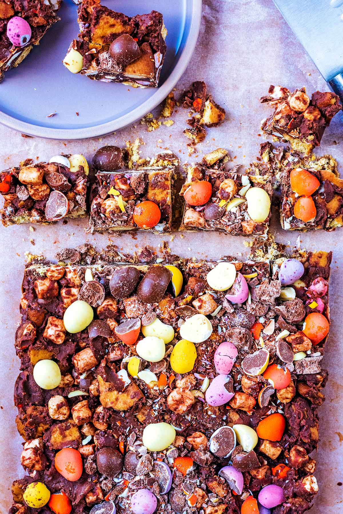 A large slab of rocky road with some cut off into squares.