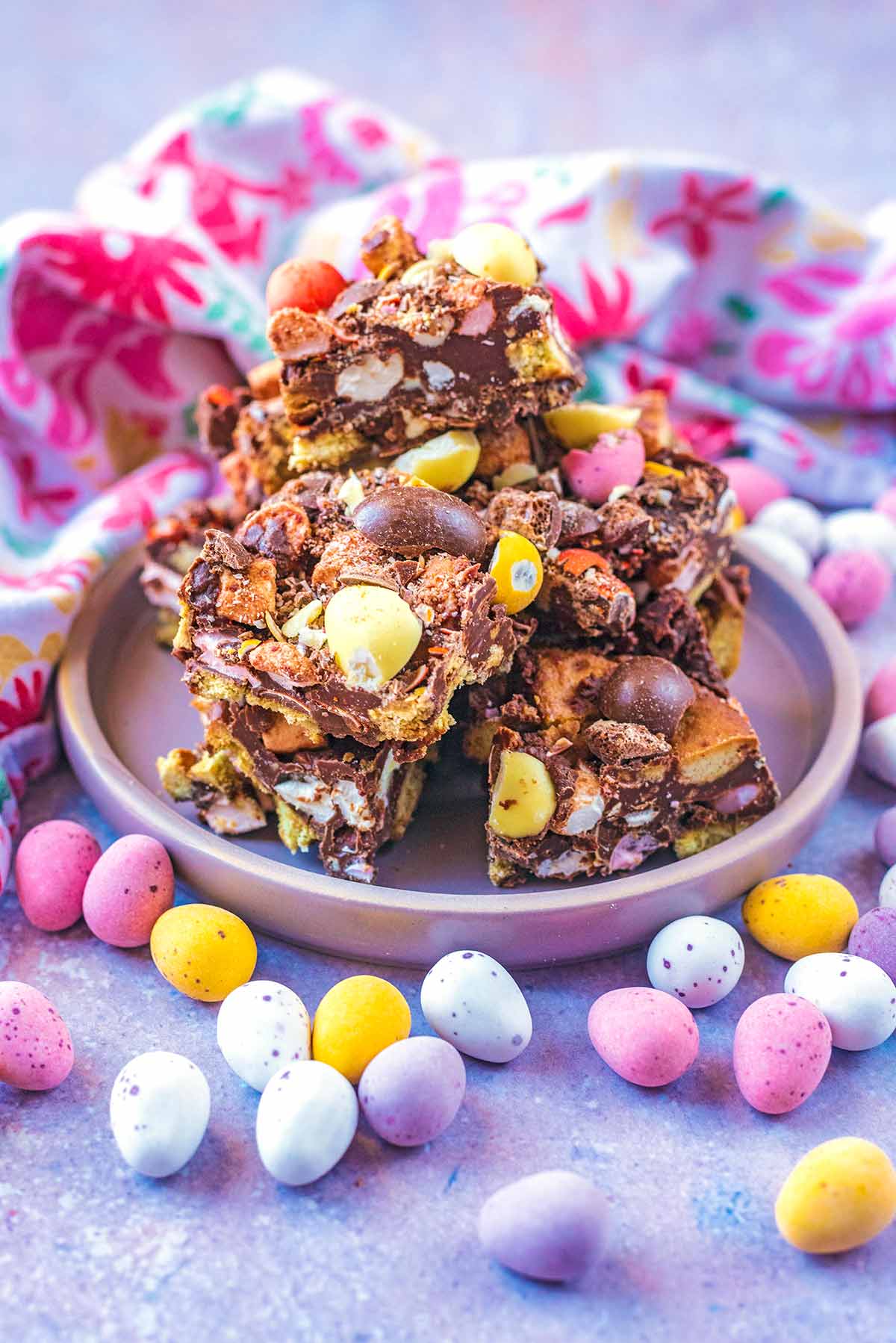 A pile of squares of rocky road on a plate.