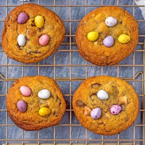 Four mini egg cookies on a cooling rack.