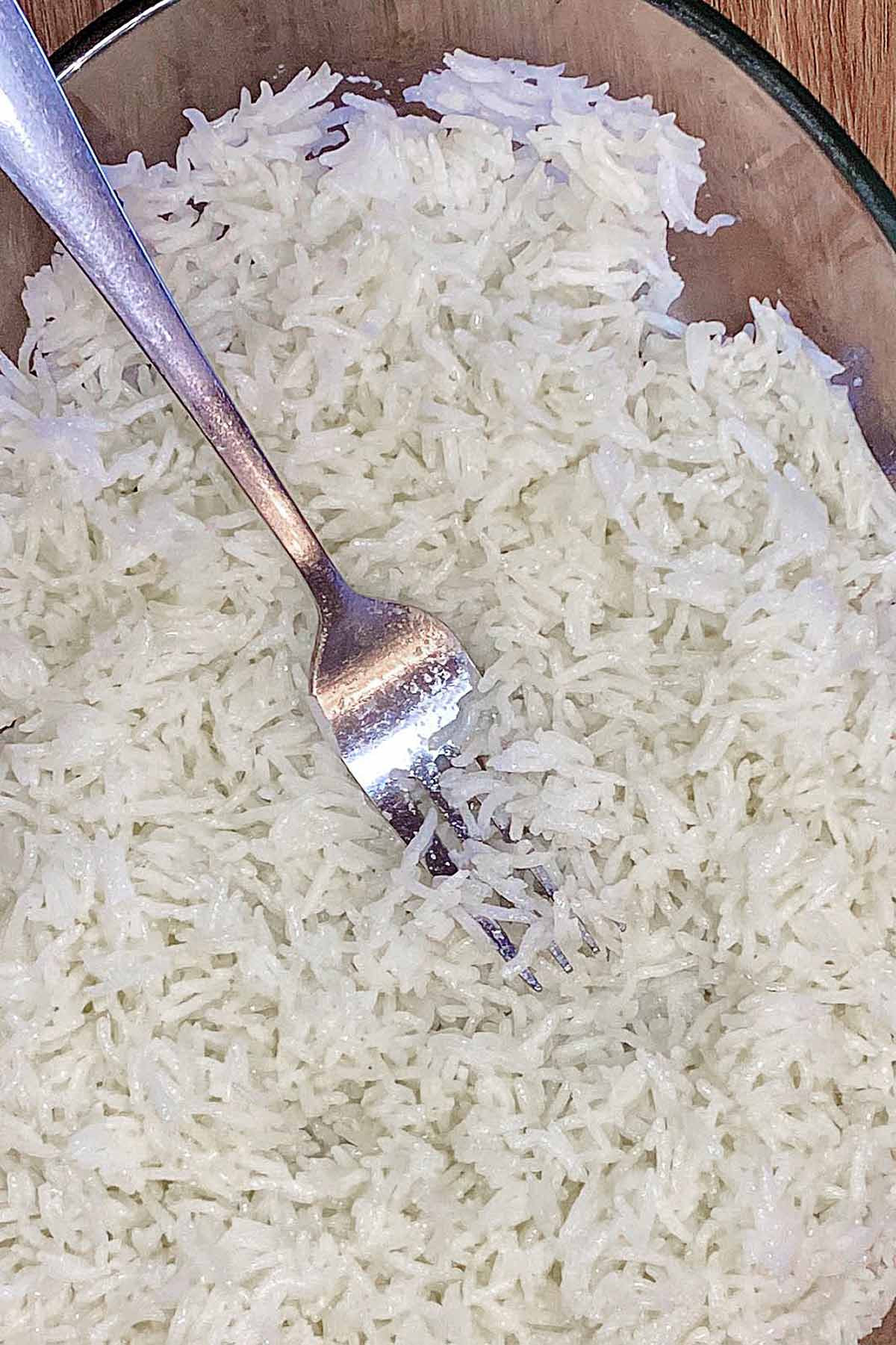 A fork in a bowl of rice.