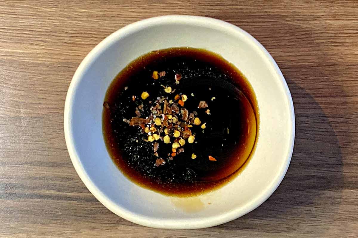 A bowl of unmixed gyoza sauce.