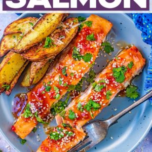 Sweet chilli salmon and potato wedges on a plate.