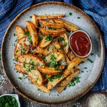 Air Fryer Potato Wedges and ketchup on a grey plate.