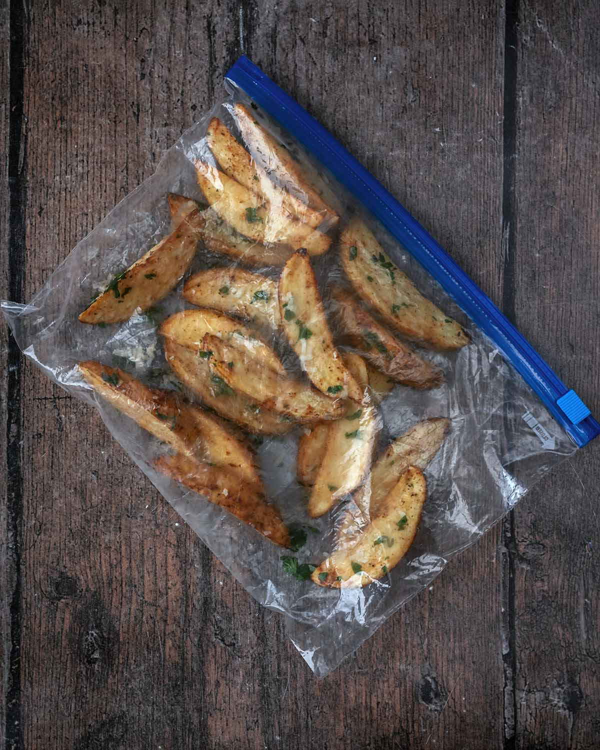 A ziploc bag full of cooked frozen potato wedges.