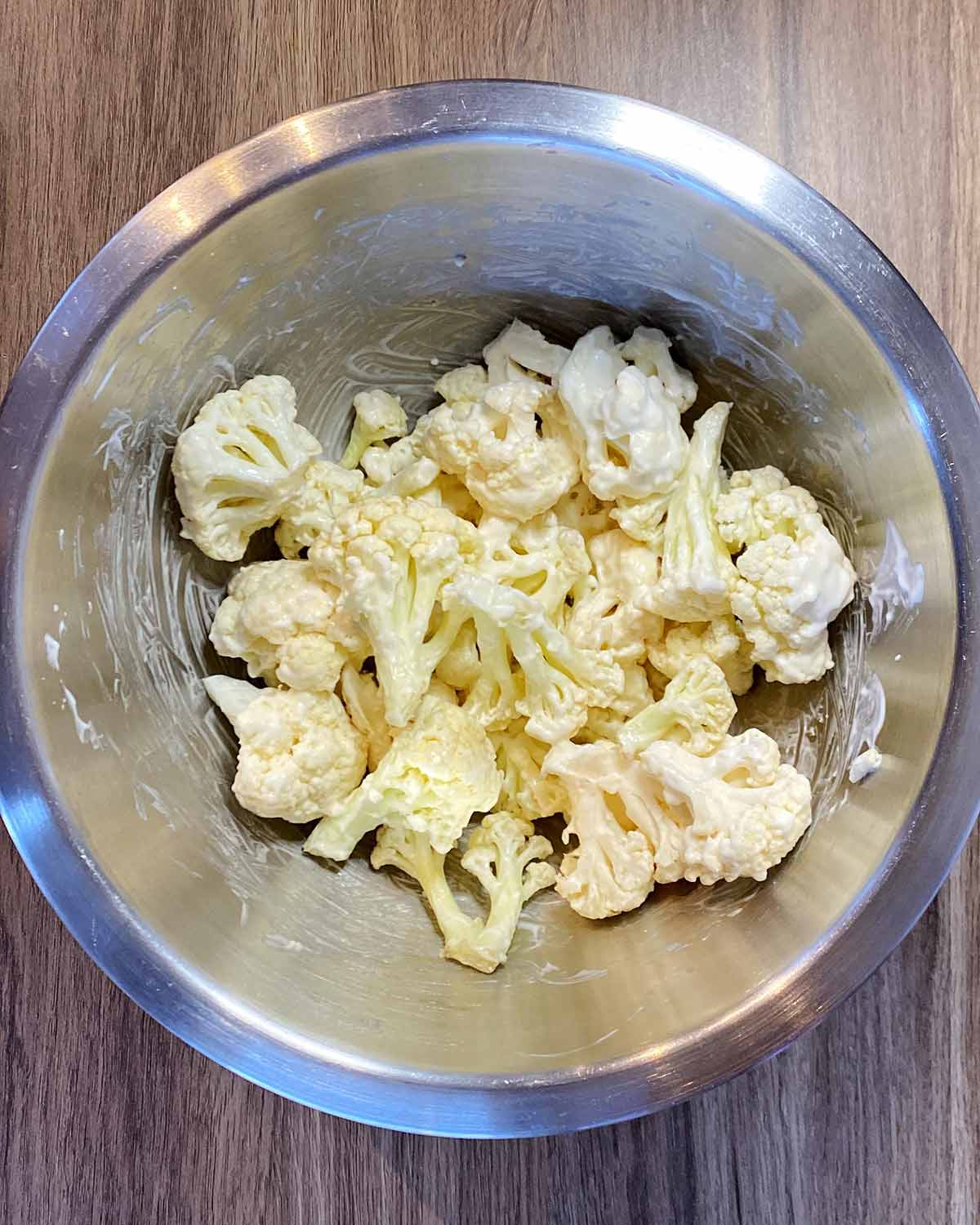 The cauliflower florets coated in mayonnaise.