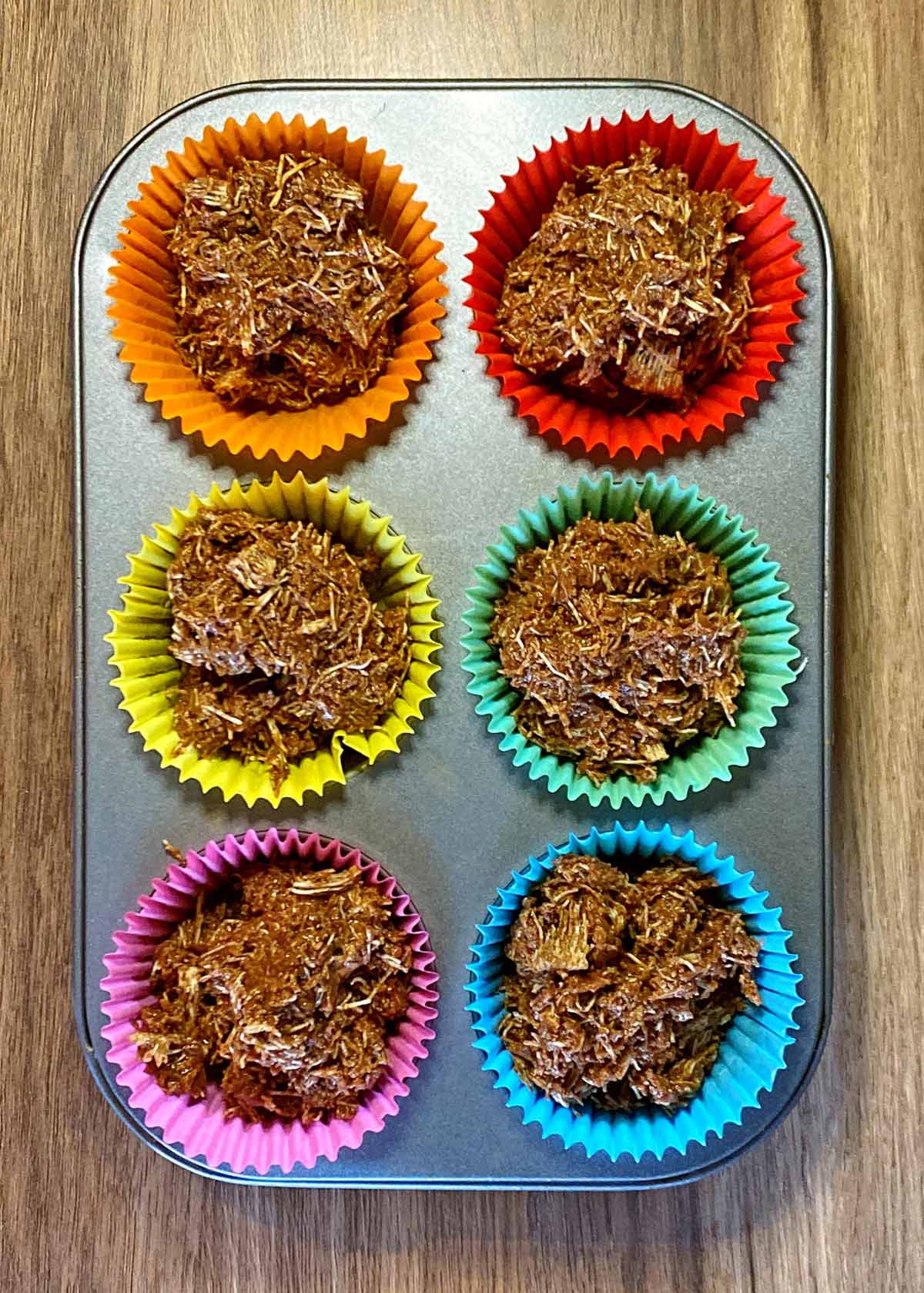 The chocolate shredded wheat pressed into six muffin cases.