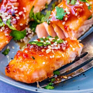 Sweet chilli salmon on a plate with a fork under it.