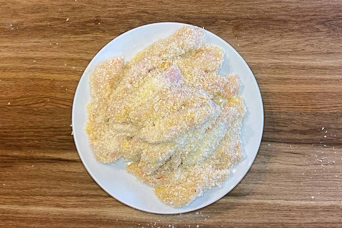 Raw chicken strips dredged in flour, egg and breadcrumbs.