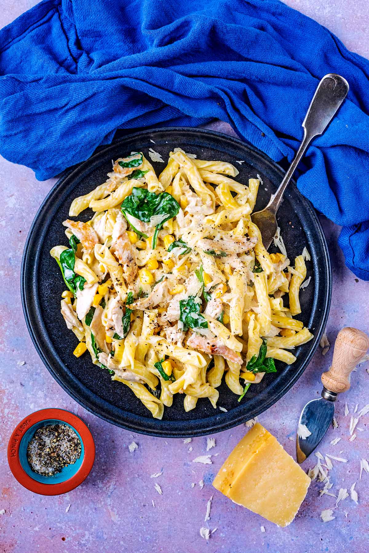 A plate of chicken and pasta in a creamy sauce.