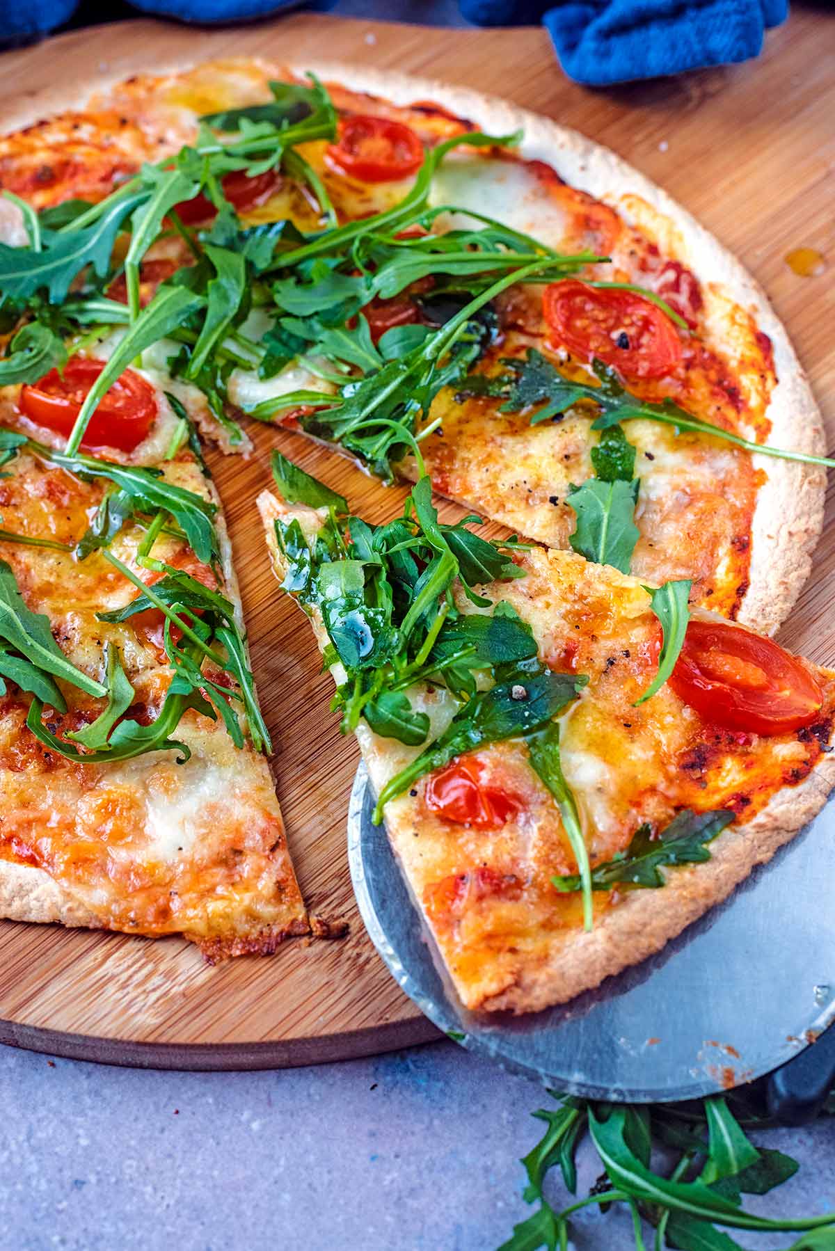 A pizza with a slice being removed from it.