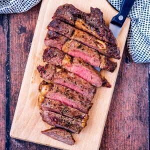 Air Fryer Steak sliced up on a serving board.