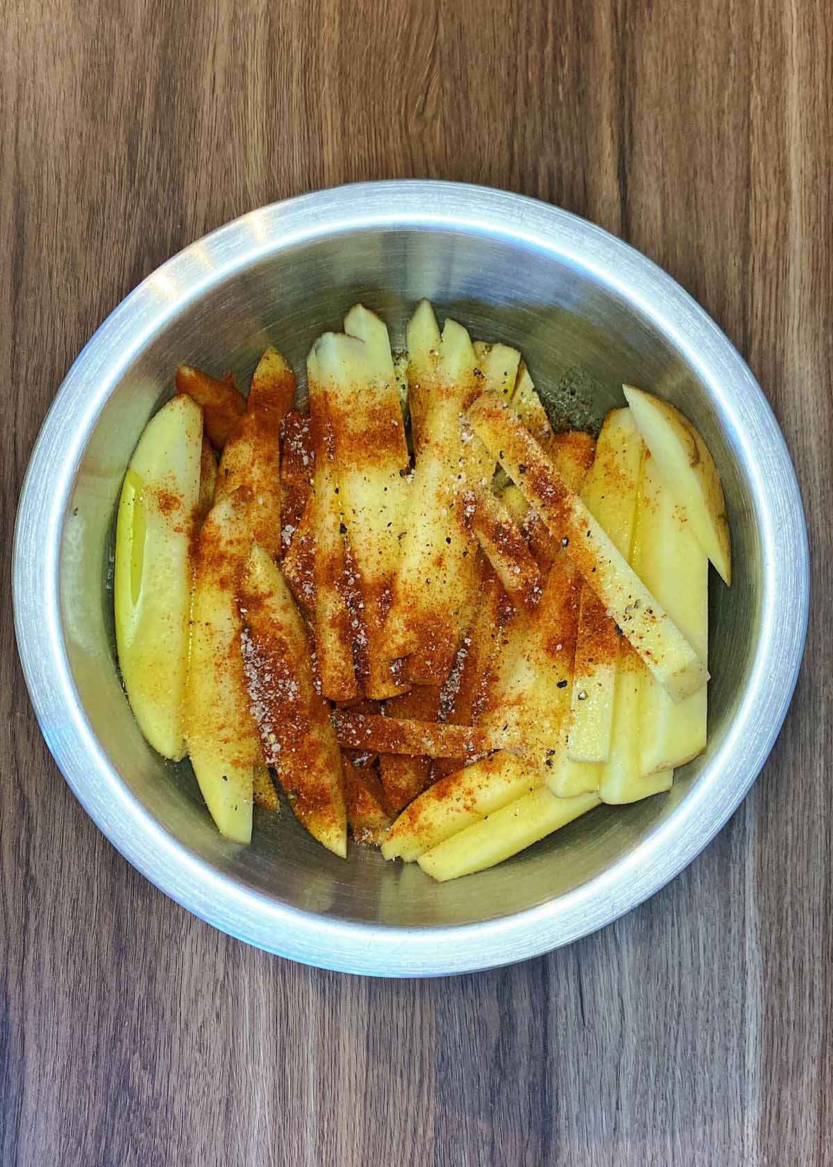 Seasoning and oil added to the chips.