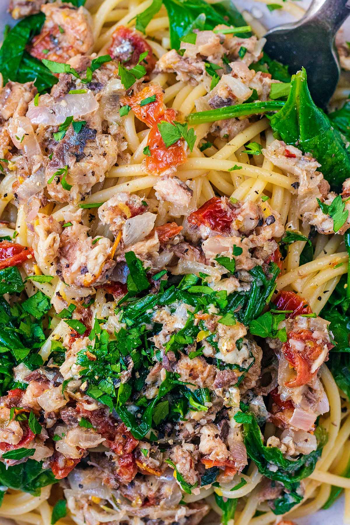 Chopped sardines, spinach and herbs mixed into spaghetti.