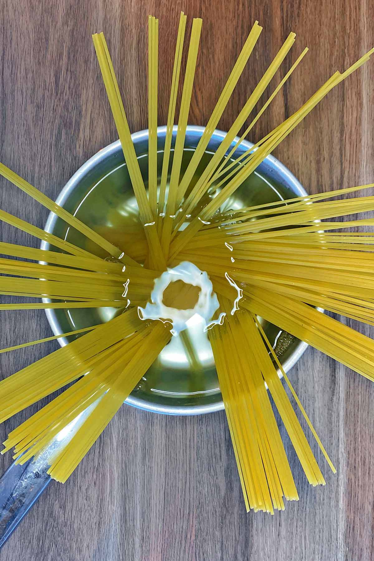 Spaghetti in a pan of water.