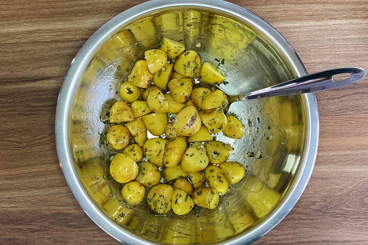 The potatoes, oil and herbs all mixed together.