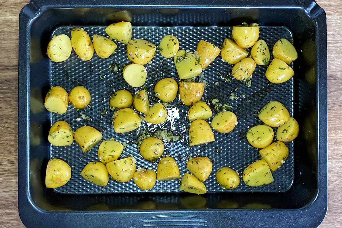 The potatoes transferred to a baking tray.