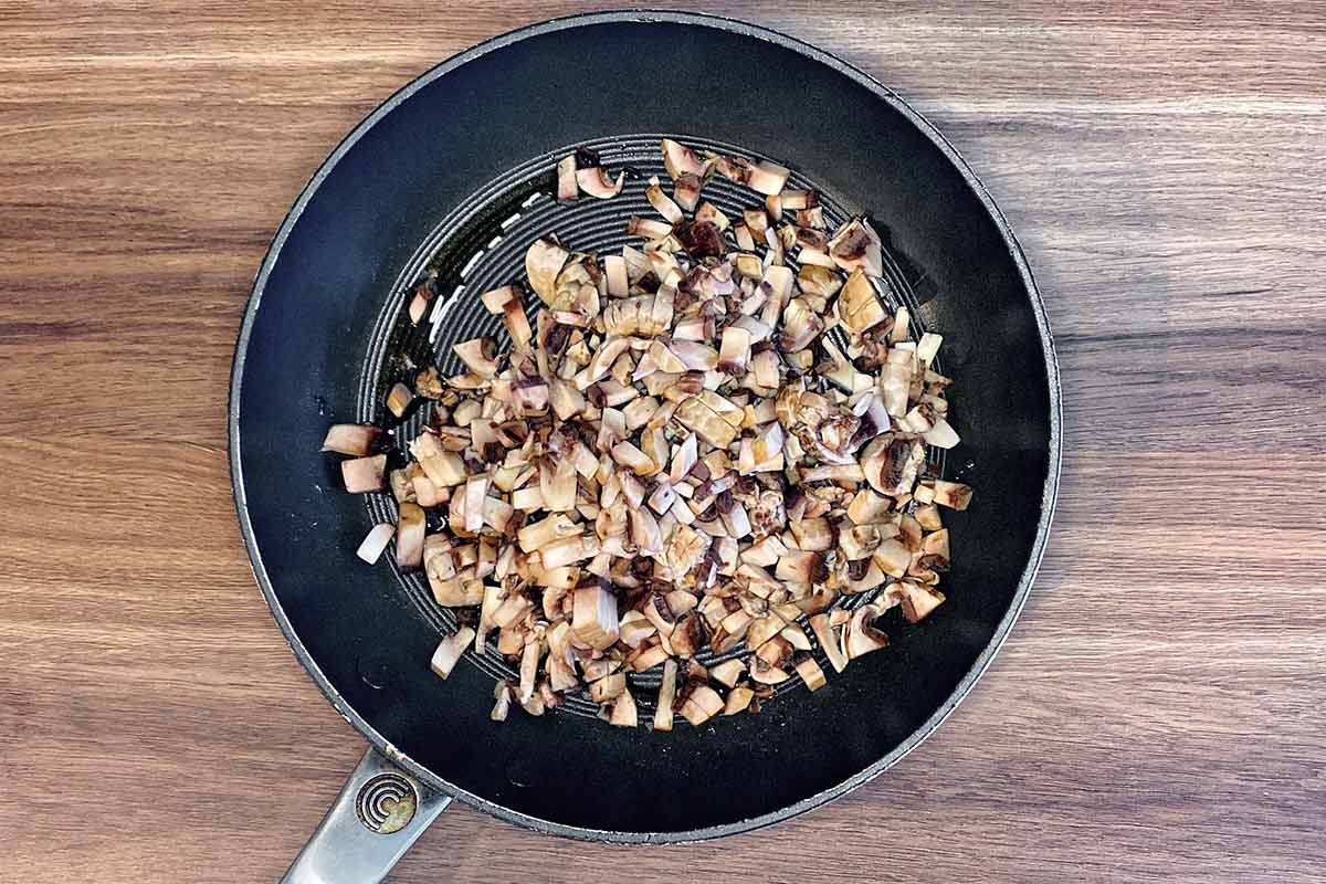 Chopped mushrooms in a frying pan.