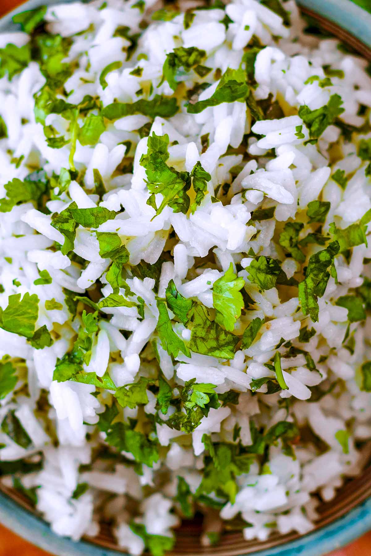 Cooked white rice mixed with finely chopped cilantro.