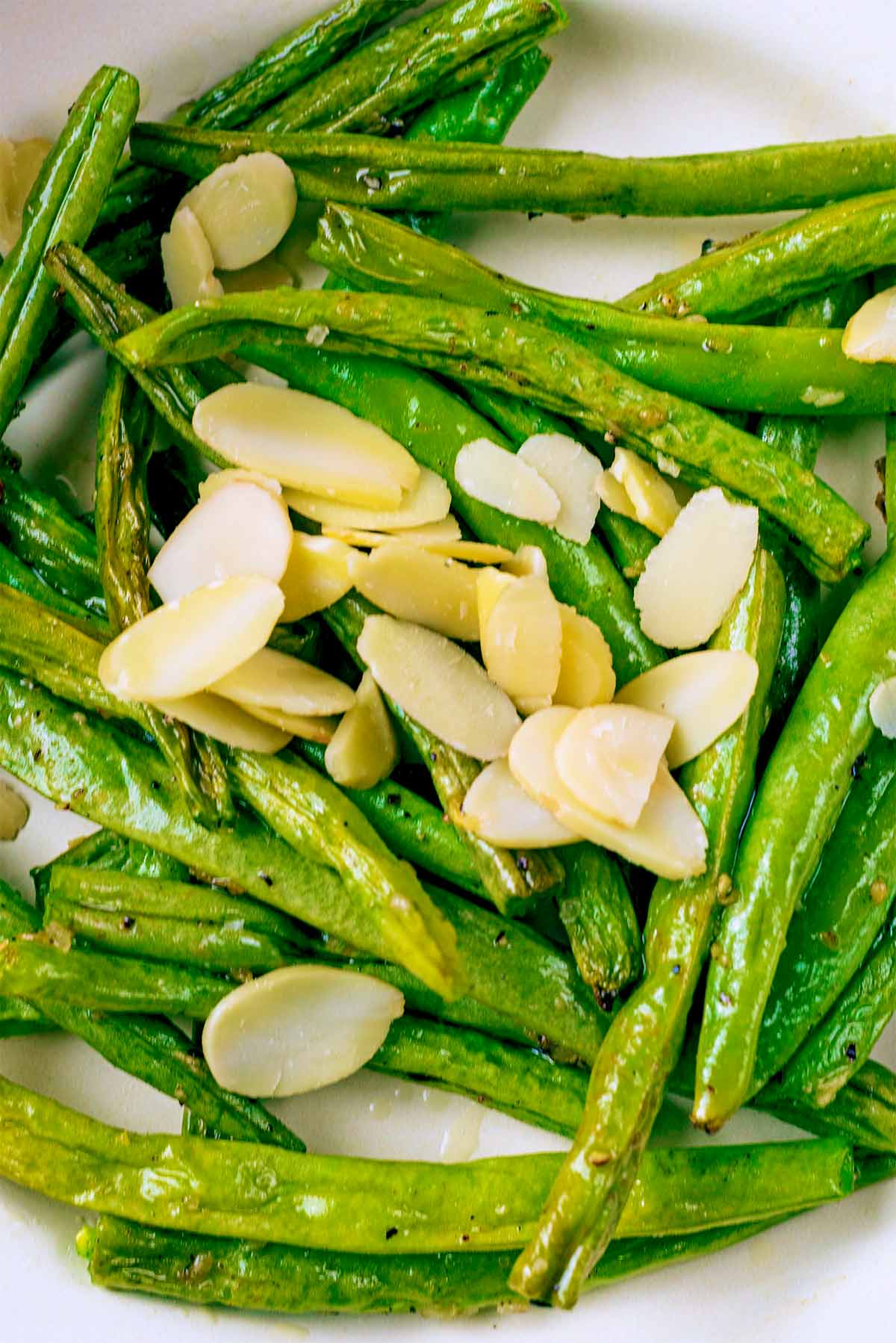 Green beans and almonds on a plate.