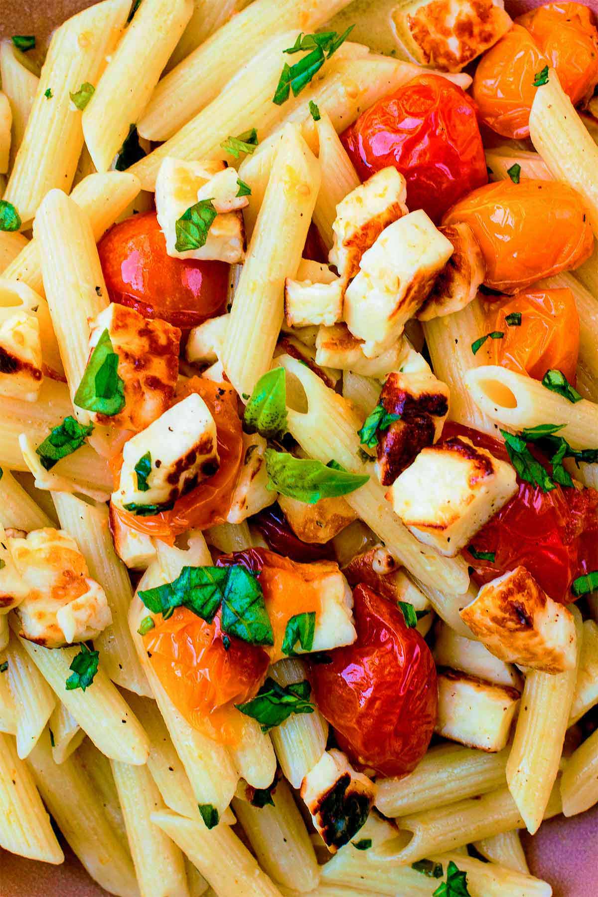 Cooked cubes of halloumi, mixed with roasted tomatoes and penne pasta.