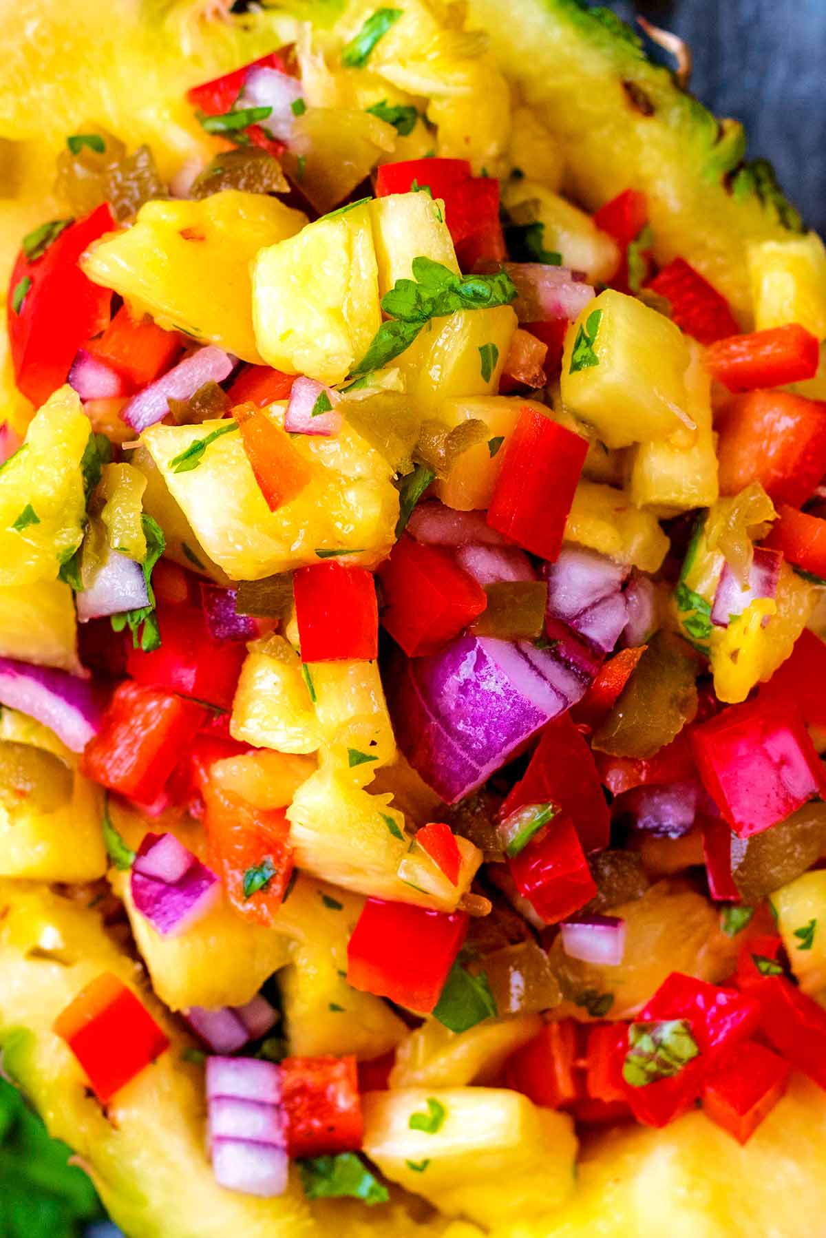 A salsa made up of pineapple, red onion, red bell pepper and chopped herbs.