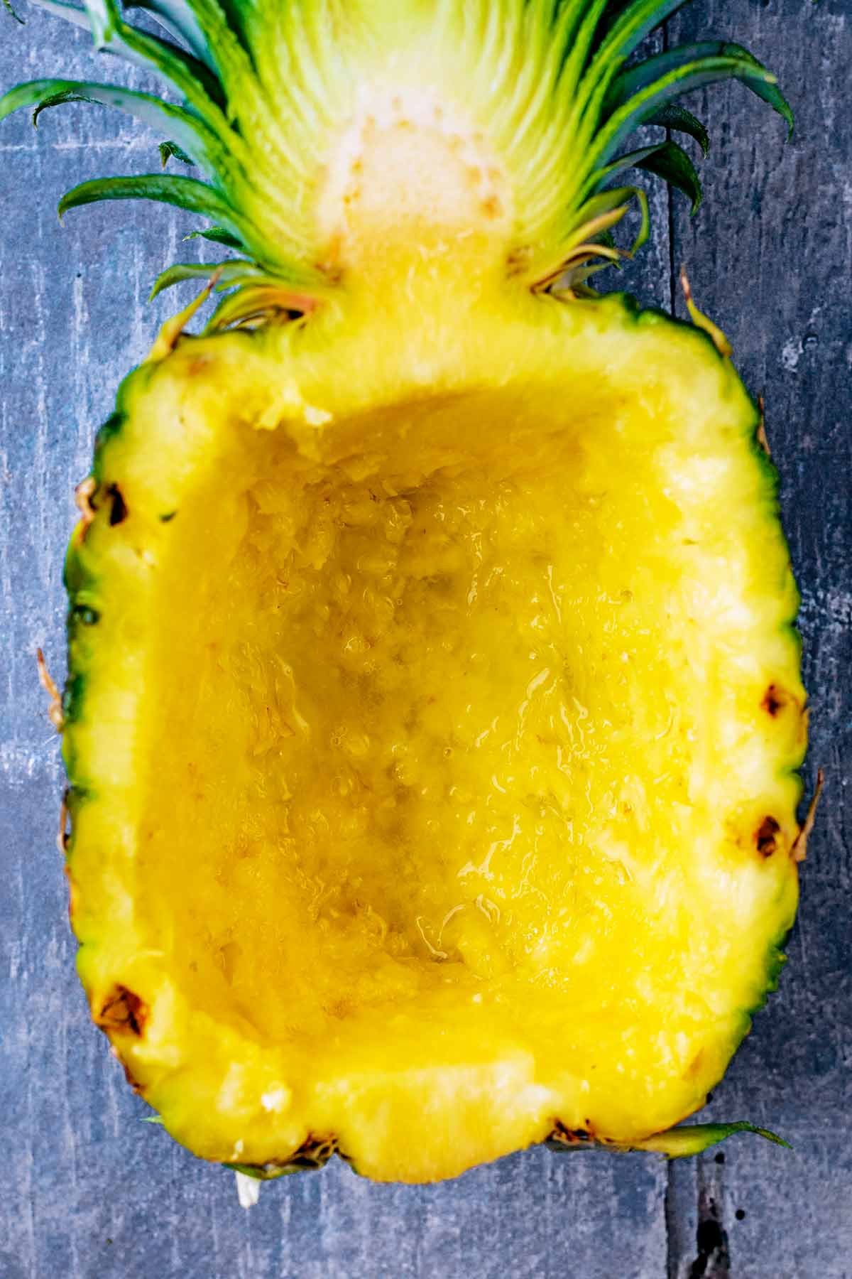 A half pineapple completely scooped out.