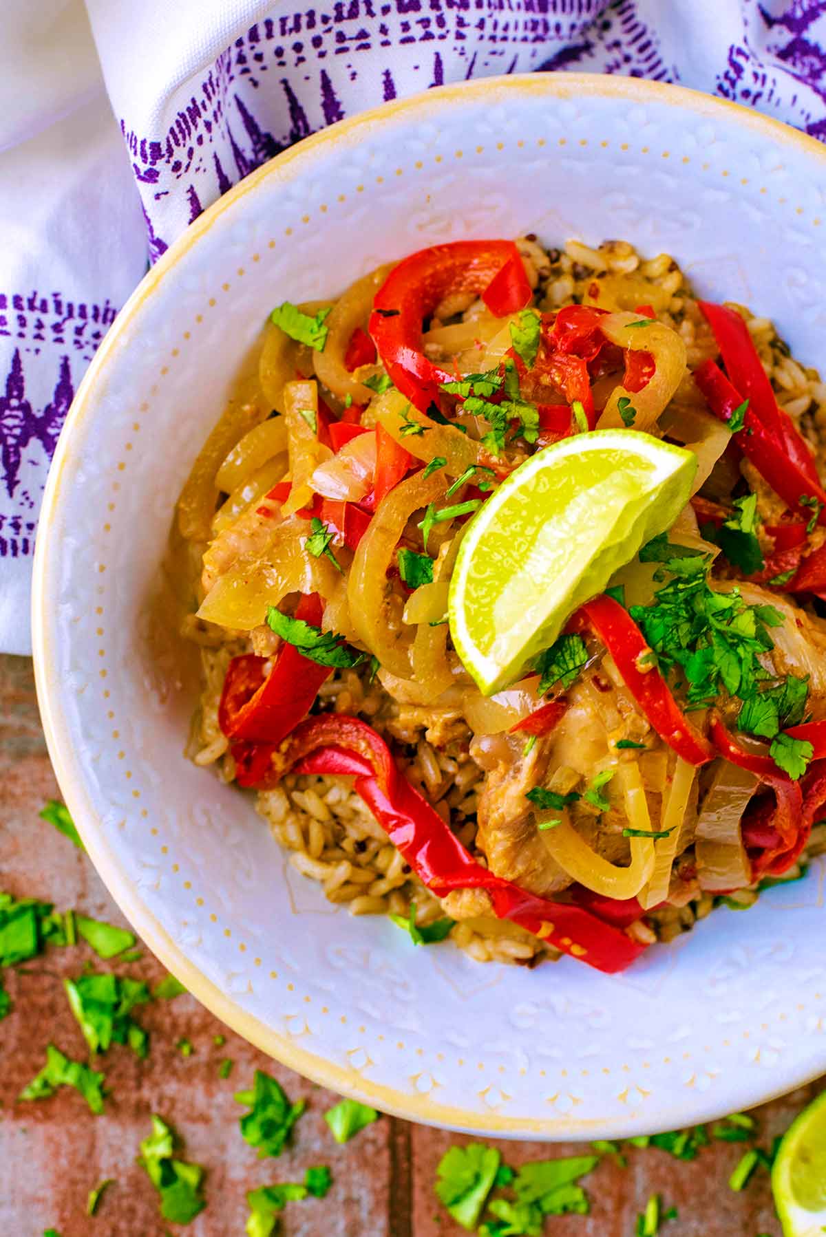 Slow Cooker Thai Chicken Curry in a white bowl with a lime wedge on top.
