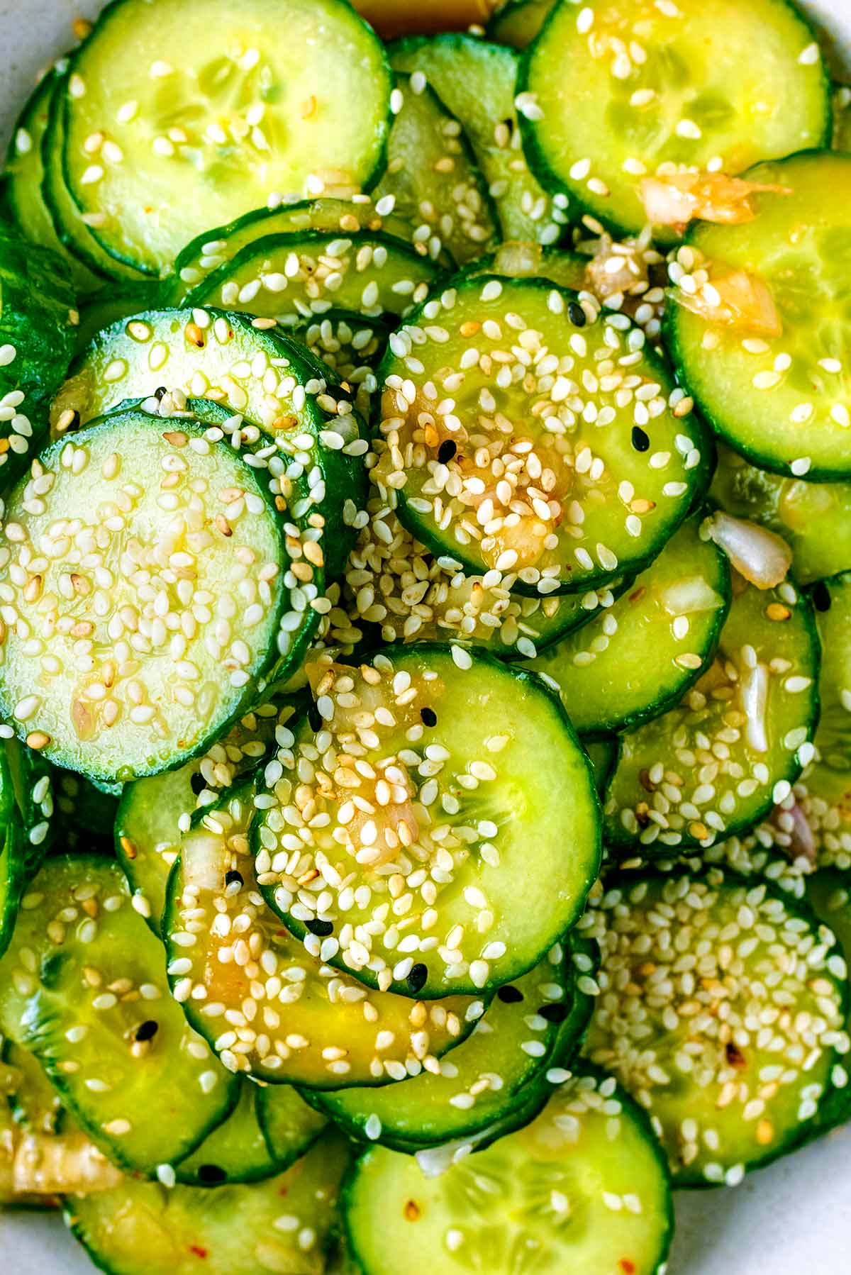 Sesame seeds sprinkled over cucumber slices.