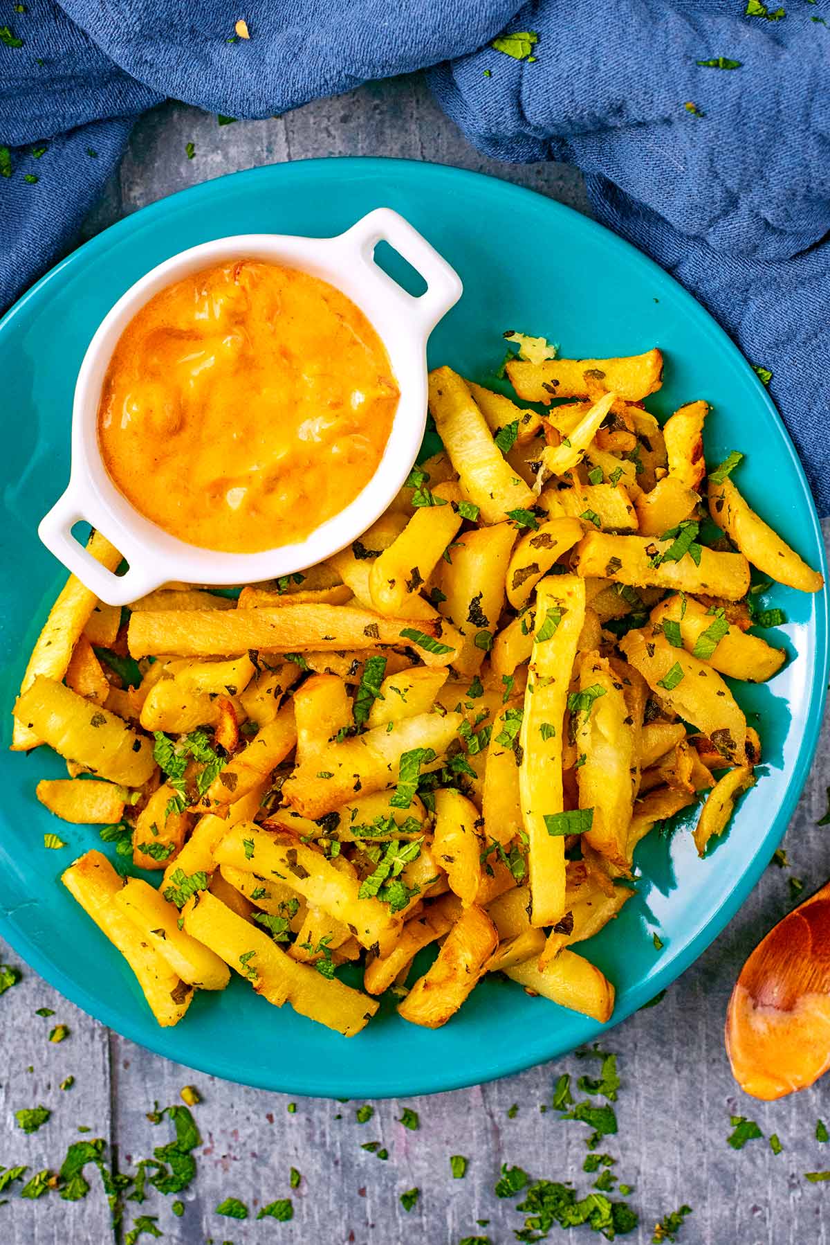 Baked Parsnip Fries on a blue plate.