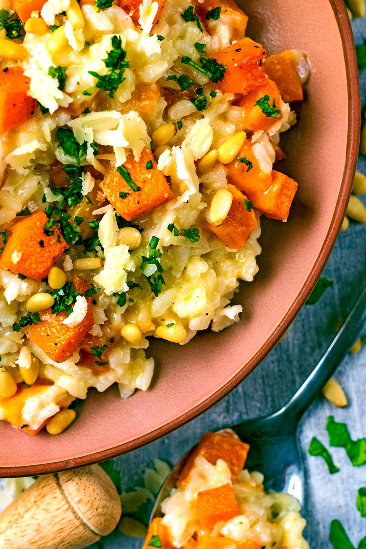 Cubes of butternut squash in a risotto with chopped herbs.