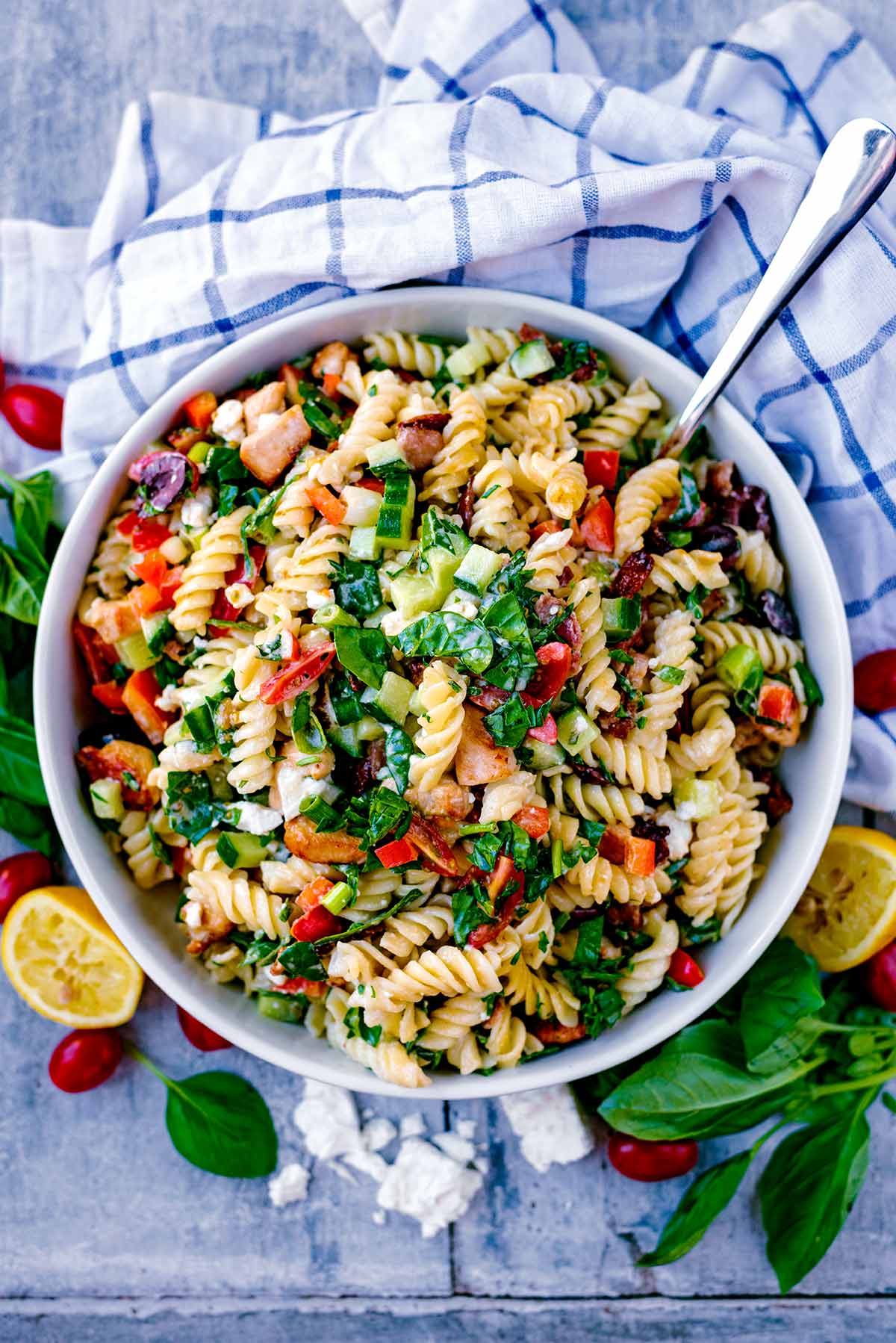 A large bowl of Chicken Pasta Salad next to a checked towel.