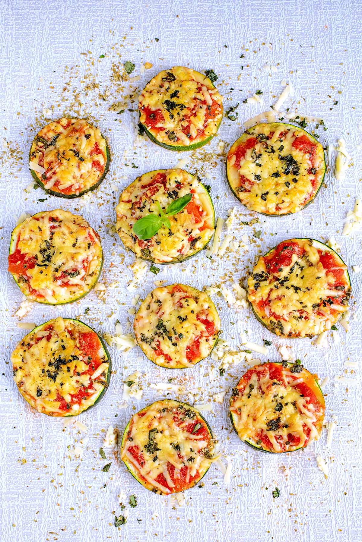 Cooked courgette pizza bites with melted cheese.